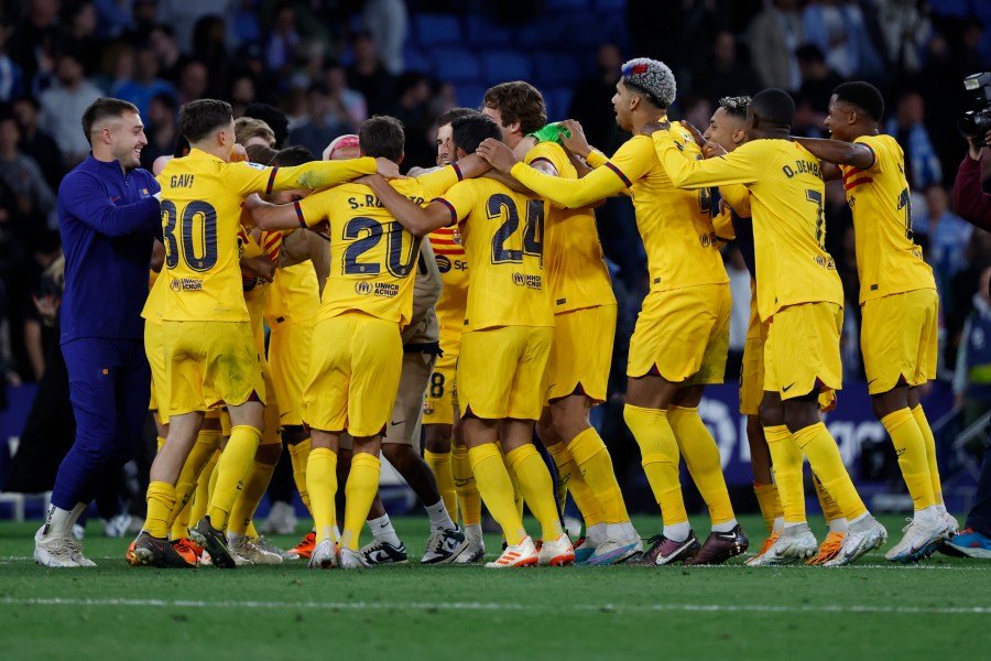 Barcelona players celebrate after the Spanish La Liga soccer match between Espanyol and Barcelona at the RCDE stadium in Barcelona, Sunday, May 14, 2023. (AP Photo/Joan Monfort)