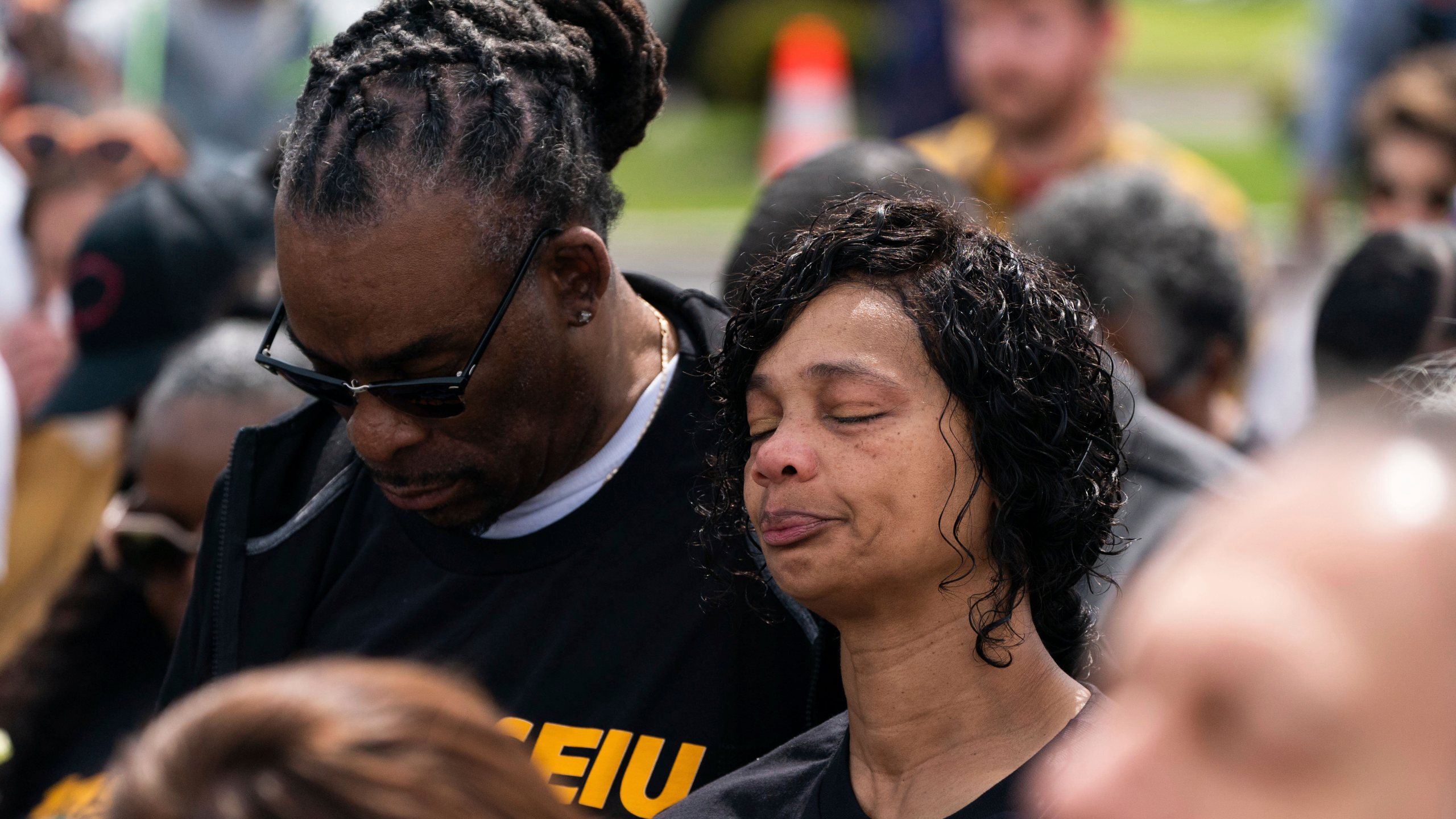 Members of the crowd pause for a moment of silence outside Tops Friendly Market during a remembrance event in honor of the victims of last year's mass shooting at the supermarket in Buffalo, N.Y., Sunday, May 14, 2023. (Joshua Bessex/The Buffalo News via AP)