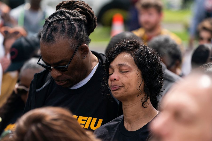 Members of the crowd pause for a moment of silence outside Tops Friendly Market during a remembrance event in honor of the victims of last year's mass shooting at the supermarket in Buffalo, N.Y., Sunday, May 14, 2023. (Joshua Bessex/The Buffalo News via AP)