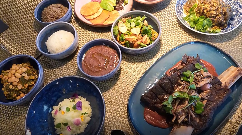 Plates of Haitian cuisine at Kann in Portland, May 2023 (KOIN)