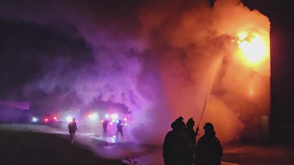 Firefighters combat an overnight blaze at a structure near Reynolds High School in Troutdale on Wednesday, May 10, 2023