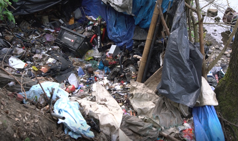 Trash near a makeshift cabin on the banks of the Willamette River in Portland, April 2023 (KOIN)